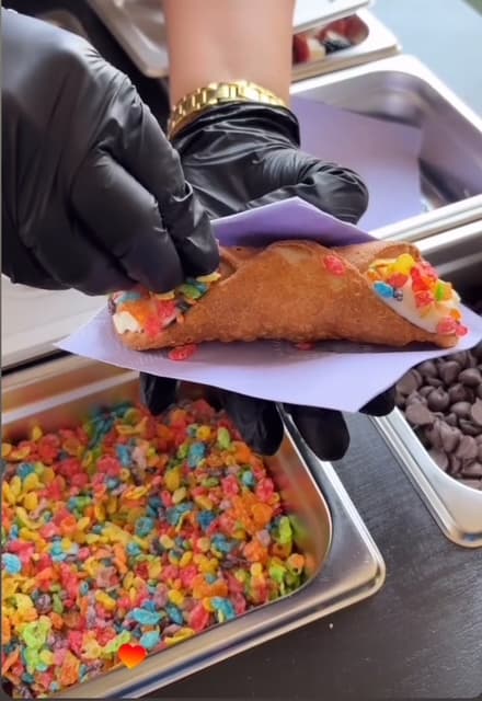 The Sacred Flame serving a delicious fruity pebbles cannoli creation.